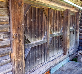 Old wooden gate to the yard in the village in summer