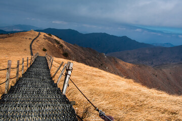 Landscape of the mountain ridge and path at Sobaeksan National Park in Danyang, South Korea during a cloudy day. 