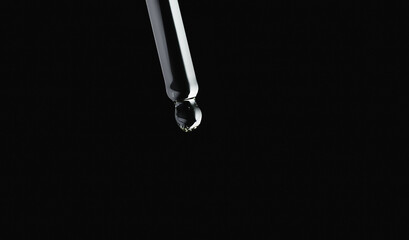 pipette with oil on a black background