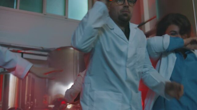 People wearing white coat running in factory building during fire