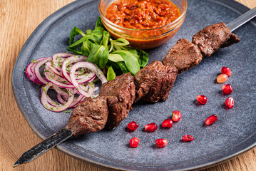 lamb kebab with sauce and vegetables
