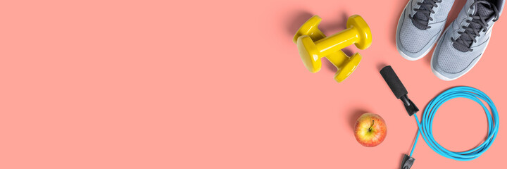 Fitness equipment on a peach background with copyspace