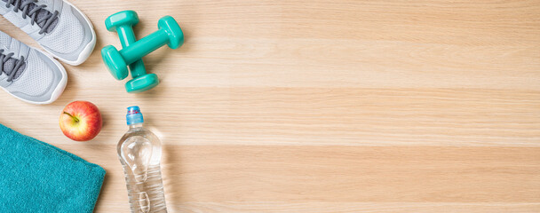Fitness equipment on a wooden background with copyspace