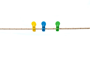 Colorful wooden clothespin hanging on rope. isolated on the white background.