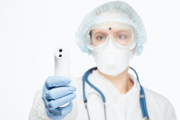 Doctor in protective suit pointing infrared thermometer to check body temperature epidemic virus outbreak concept