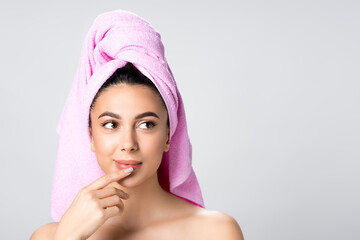 dreamy beautiful woman with towel on hair isolated on grey