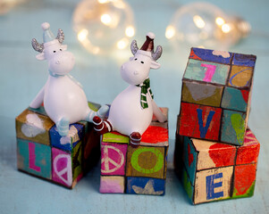 decorative gobies sitting on rebus cubes, with the encrypted word love, made at home, on a wooden...