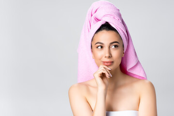 dreamy beautiful woman with towel on hair isolated on grey
