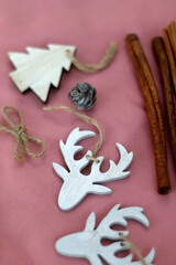 Various Christmas decorations on pink background. Selective focus.