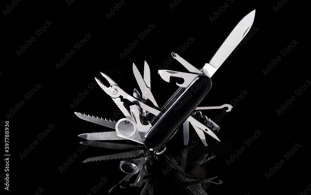 Wall mural multipurpose pocket knife on black background