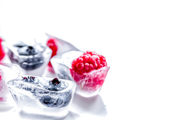 fresh blueberry and raspberry in ice on table background mock-up