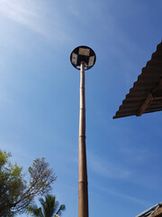 The lamp uses solar energy.  Using bamboo trunks as pillars