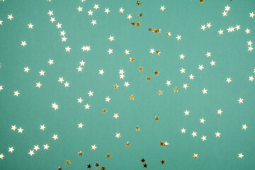 Fototapeta na wymiar Festive green background with Golden glittering stars