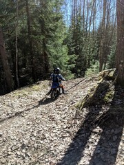 Obraz premium A little boy is enjoying his motocross ride in various poses on nature trails.