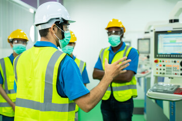 factory worker man and worker woman training about operating machine with one point to monitor,checking machine in factory.management system to support industrial business working concept