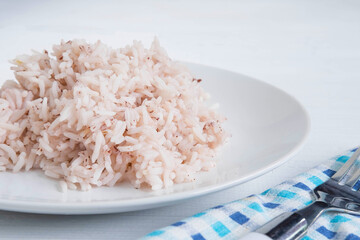 Brown rice and steamed rice on a plate