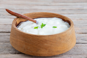 .Healthy natural yoghurt on a wooden table