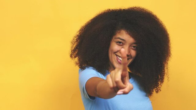 Young african american curly woman showing number one with finger