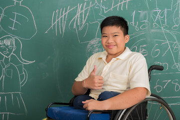 Portrait of young Asian disabled child student on wheelchair in happy and smile emotion acting thumbs up in element classroom