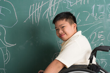 Portrait of young Asian disabled child student on wheelchair in happy and smile emotion in element classroom