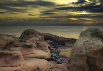 Natural sandstone rock formations at sunrise at Crail, fife, Scotland.