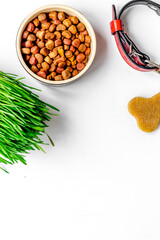 dry dog food in bowl on white background top view