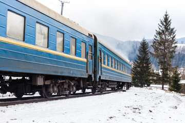 Fototapeta premium Old steam train in the snow in winter