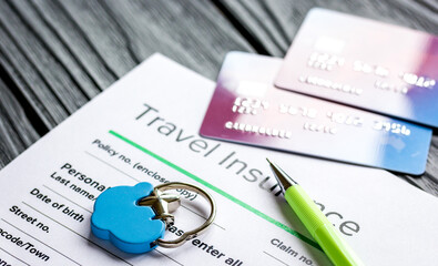 Travel preparation concept with insurance and cards on wooden table