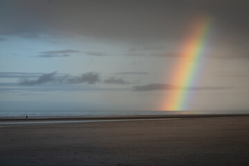 Rainbow on the Beach with clouds