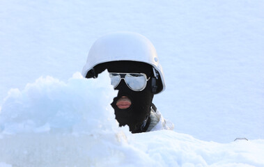 Fototapeta na wymiar winter portrait of a soldier in a black mask