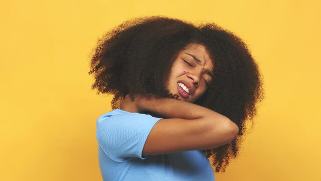 Young african american curly woman suffering neck pain due to sedentary lifestyle