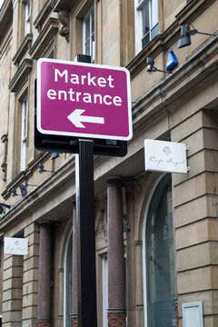 Street Road Sign Giving Directions To Market Entrance.  Information For Tourists And Shoppers