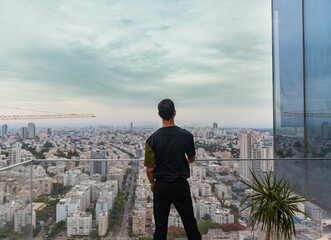 Man on skyscraper balcony in tel aviv