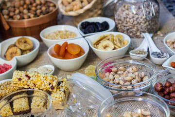 Granola Bars and mixed nuts. Honey bars with peanuts, chocolate, dried fruit, sesame and sunflower seeds