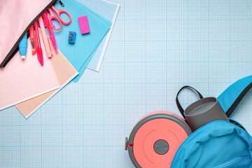 School stationery and a container of food in a backpack. Top view. New normal.