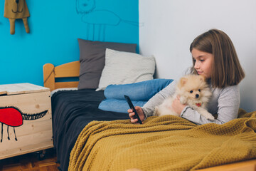 teenager girl relaxing in her room with her dog