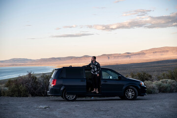 Fototapeta na wymiar young man living in his van in the mountains