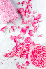 organic cosmetic with rose salt and towel on white background top view