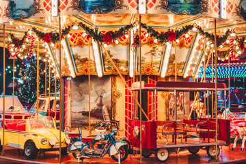 Fototapeta na wymiar Illuminated Christmas carousel in the amusement park