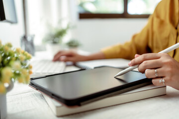 Artist or creative designer drawing on digital tablet with new project design..