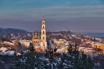 Naklejka premium Old Russian city in winter. City of Yurievets in winter. Winter sleep. Snow-white bell tower of the city. Panorama of the old city.