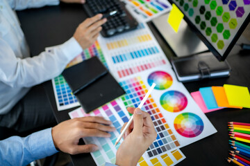 Creative graphic designer team working with colour swatch sample, Brainstorming ideas in studio..