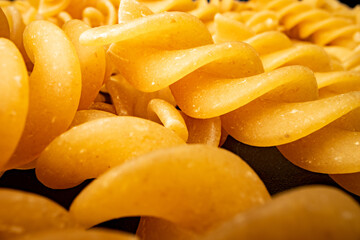 Macro photo of dry heap of fusilli pasta