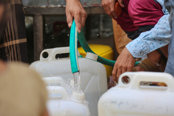 A child fills water due to the water crisis in the city of Taiz since the beginning of the war in...