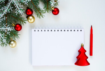 New Year goal list 2021. notebook for writing about plan listing of new year goals and resolutions setting on white background with Christmas tree and red glitter balls and snowflakes . Wish list.