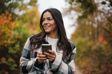 Smiling attractive woman using mobile phone