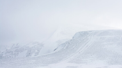 Fototapeta na wymiar Ice-covered racing slope against a background of haze.