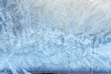 Beautiful natural background or texture of frozen transparent glass on the window in winter, strong cold concept, horizontal image, copy space for your design or text