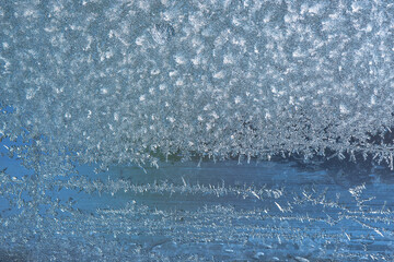 Beautiful natural background or texture of frozen transparent glass on the window in winter, strong...