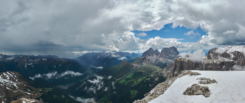 Panoramic view of the Dolomites Alps and Fassa Valley, Italy. Thunderstorm and rain over the mountains